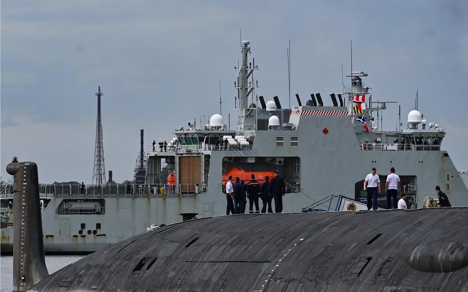 The crew of the Russian nuclear-powered cruise missile submarine Kazan watch the Canadian navy patrol boat HMCS Margaret Brooke passing by as it enters the bay in Havana, Cuba, on June 14, 2024.