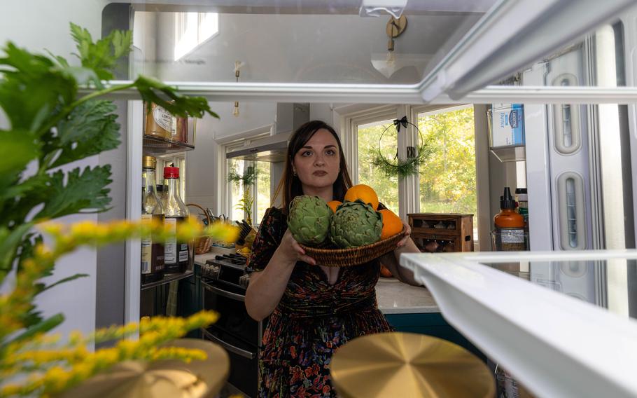 Lynzi Judish places a bowl in her Halloween-themed fridge. 