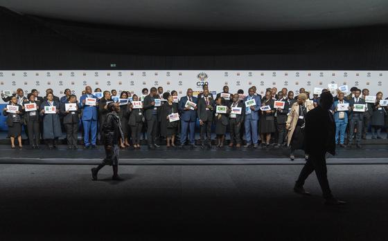 Placeholders prepare for a family photo of the G20 foreign ministers meeting that was later cancelled in Johannesburg, South Africa, Thursday, Feb. 20, 2025. (AP Photo/Jerome Delay)