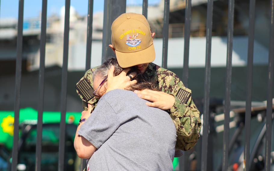 Seaman Mason Baker hugs his mother before he sails on the USS Harry S. Turman