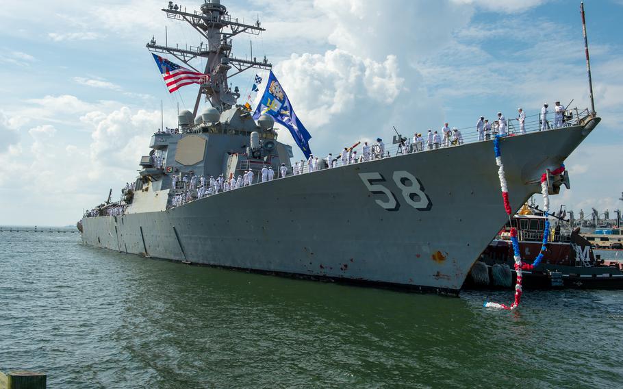 USS Laboon is guided by a tugboat