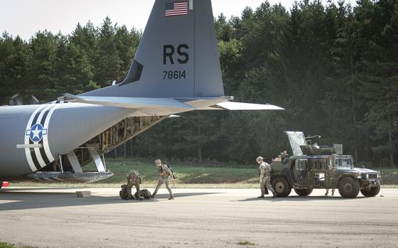 U.S. soldiers participating in exercise Saber Junction unload a Humvee and weapons from an Air Force C-130 at the Joint Multinational Readiness Center in Germany on Sept. 5, 2024.