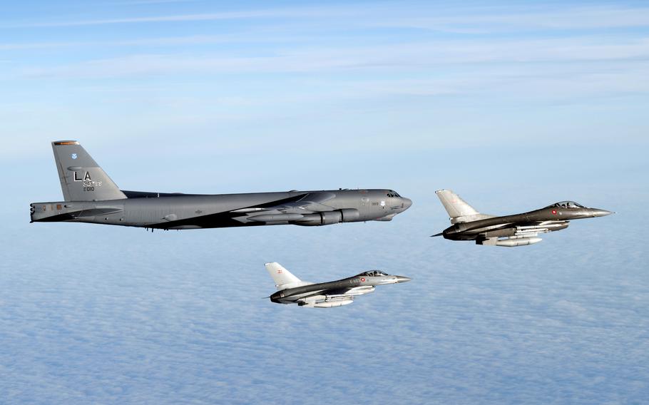 A U.S. bomber flies with two Danish F-16s above the Baltic Sea.