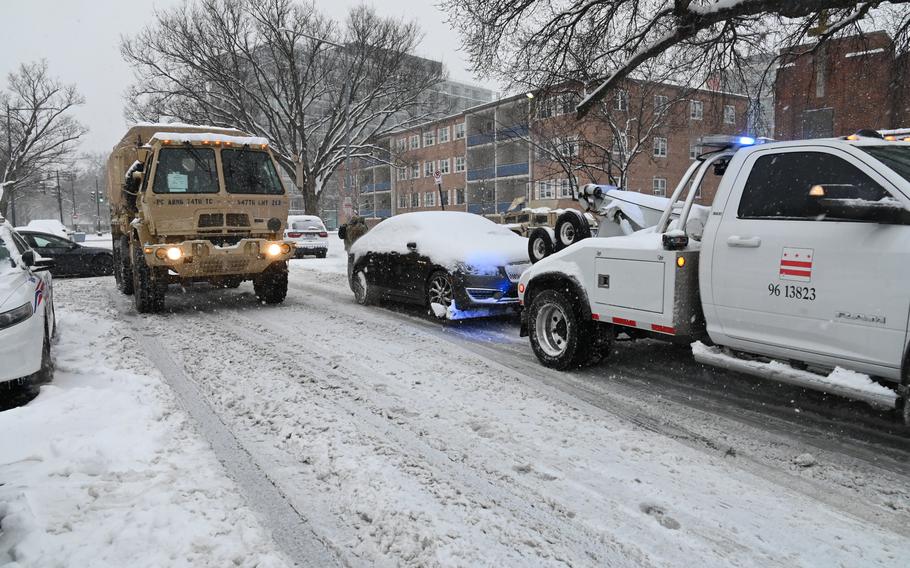 A vehicle being towed out of the snow