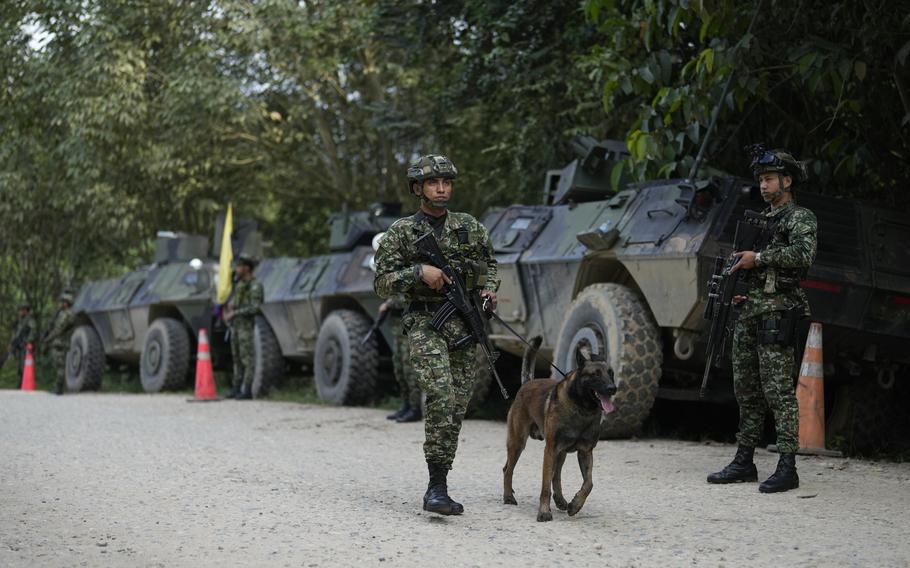 Soldiers patrol a road