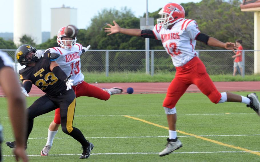 Kadena receiver Flint Barton and Kinnick's Joseph Mauldin go up for a pass as Red Devils defender Arashi Blocton lunges to help. The pass fell incomplete and pass interference was called on Kinnick. Barton scored two touchdowns for the Panthers.