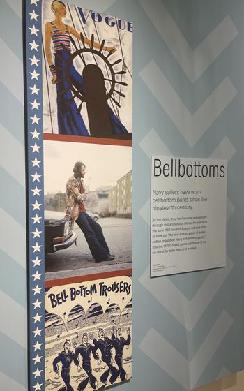 A vertical strip of three illustrations to the left of an explanatory placard shows the early history of bell bottom pants, Bremerton, Wash.