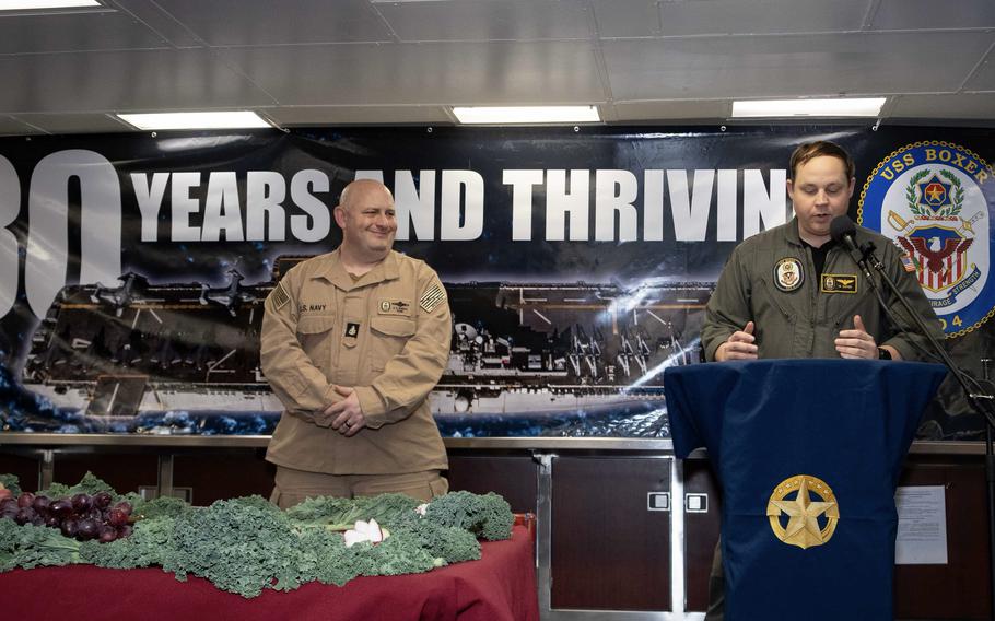 A sailor speaks to the crew during a ceremony