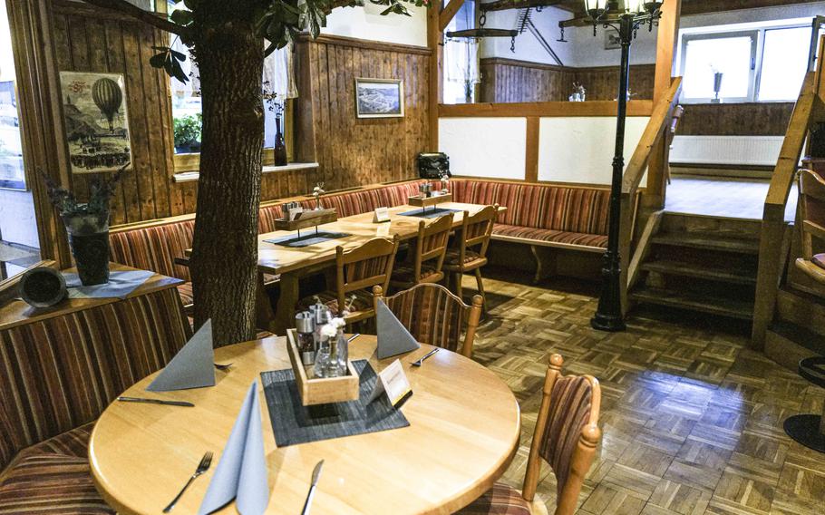 The cozy, rustic interior of Zum Landgrafen in Ludwigswinkel, Germany, offers traditional charm mixed with modern comfort. During the summer, the eatery also offers a comfortable curbside seating area.