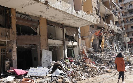 A woman walks past buildings damaged by Israeli strikes in southern Beirut's Ruweiss district on Nov. 11, 2024, as the war continues between Israel and the Lebanese militant Hezbollah group. Hezbollah said on November 11, that the Israeli military has been incapable of occupying even a single village in Lebanon since launching cross-border ground operations six weeks ago. (Anwar Amro/AFP/Getty Images/TNS)