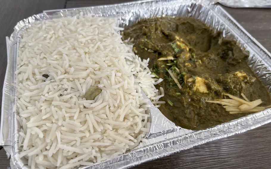 A carryout container holding palak paneer and rice from Singh’s Tandoori Indian Restaurant in Wiesbaden, Germany. The spinach-and-cheese curry is a classic dish of northern India.  