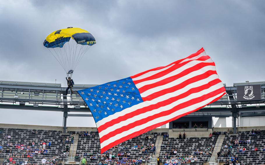 The U.S. Navy parachute demonstration team descends into MetLife Stadium.