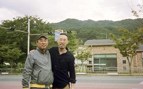 In this photo provided by Robert Calabretta, right, he and and his biological father, Lee Sung-soo, stand together for a photo while on a visit in Daegu, South Korea, in August of 2020, during the COVID-19 pandemic.