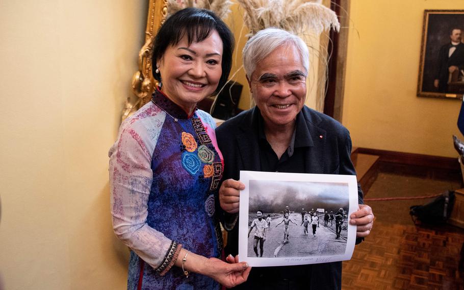 Vietnam War survivor Kim Phuc Phan Thi, left, also known as the “Napalm Girl,” poses with photojournalist Nick Ut holding his 1972 Pulitzer Prize and World Press Photo award-winning photograph.