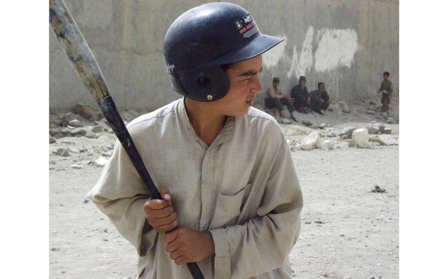 Abdul Haq gets ready for the pitch during a baseball game in Orgun-e, Afghanistan. 