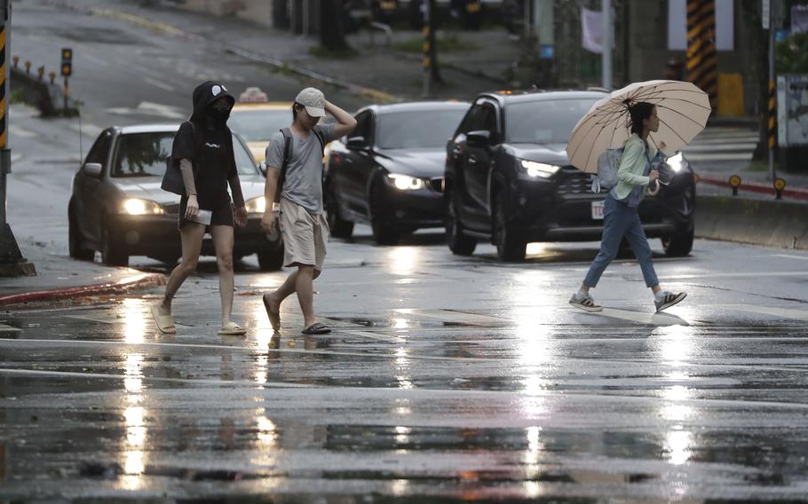 People walk in the rain