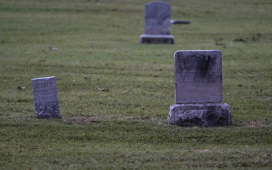 The graves of Tulsa Race Massacre victims Reuben Everett and Eddie Lockard are seen at Oaklawn Cemetery in Tulsa in 2020. 