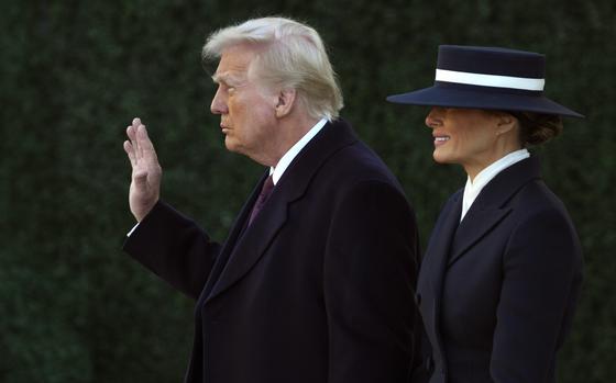 President-elect Donald Trump waves as he walks with his wife Melania after a church service at St. John's Episcopal Church across from the White House in Washington, Monday, Jan. 20, 2025, on Donald Trump's inauguration day. (AP Photo/Matt Rourke)