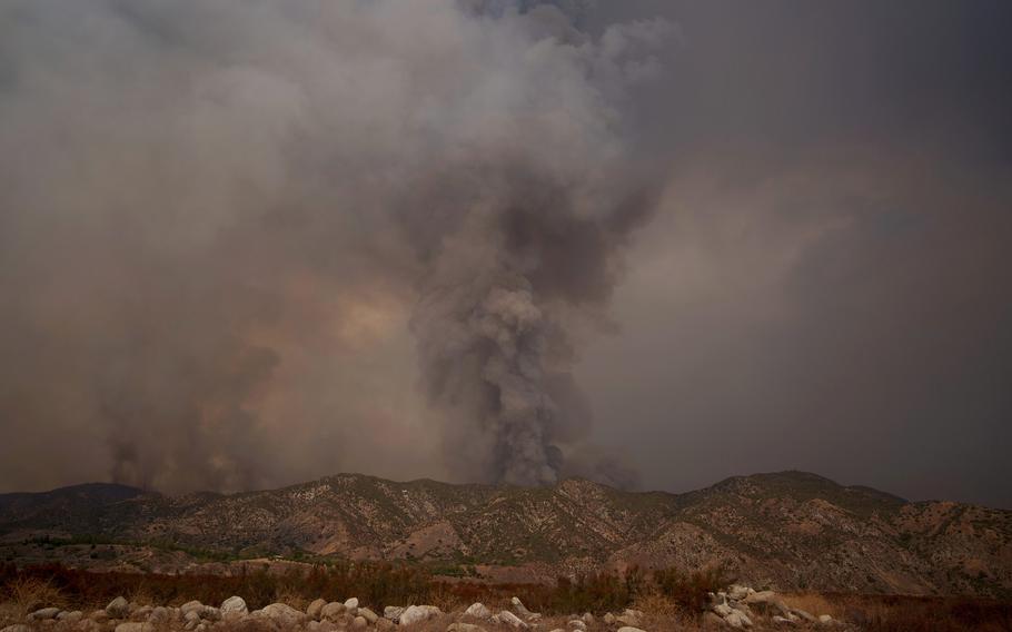 Smoke rises from a wildfire in San Bernadino County