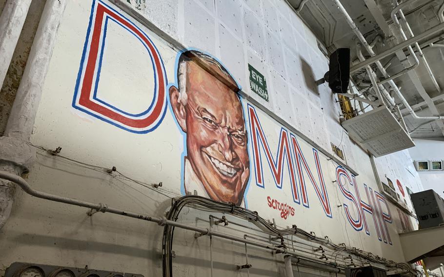 A mural painted by a sailor in the hangar bay⁤ of the‍ aircraft carrier USS Dwight D. ‌Eisenhower depicts the ship's namesake over the words "Best ⁤Damn Ship in the Navy." 