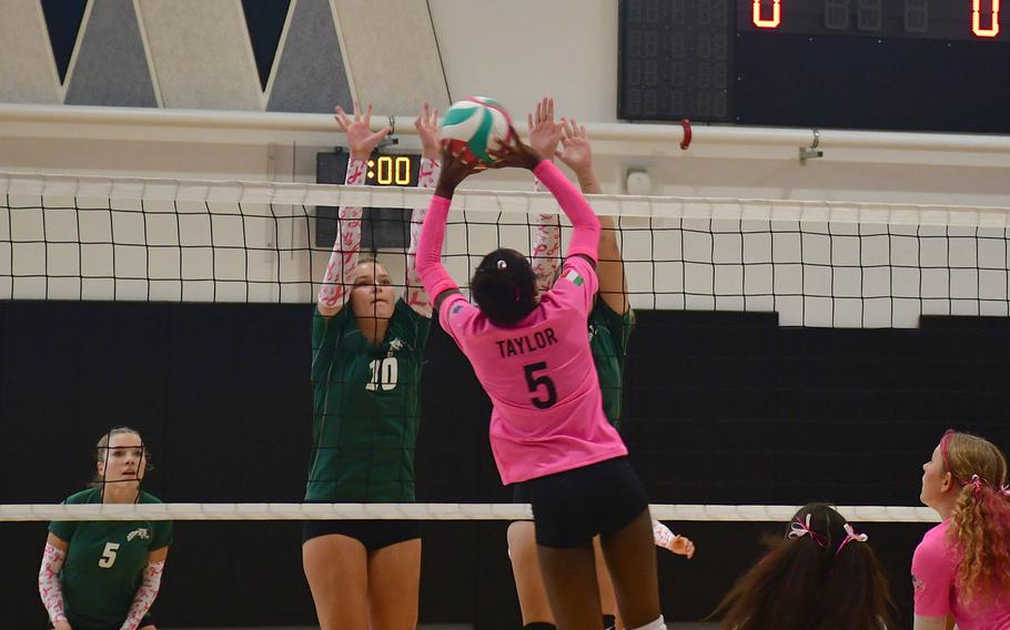 Vicenza’s Ally Taylor softly hits the ball over a pair of Wildcat defenders during the first set as the Vicenza Cougars play the Naples Wildcats at Vicenza High School on Oct. 13, 2023. 