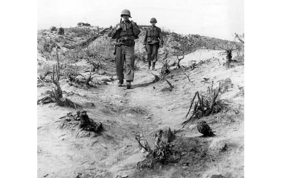 Korea, May, 1953:  Two American soldiers cross the battered terrain surrounding Outpost Harry, where enemy troops regularly mounted attacks from three sides. One sergeant recalled a battle during which "the first Red I met came along the trench yelling 'Comrade, comrade' holding a grenade in one hand and firing a burp gun with the other." In mid-June, 1953, the Americans weathered an eight-day assault by more than 13,000 Chinese troops.

Looking for Stars and Stripes’ coverage of the Korean War? Subscribe to Stars and Stripes’ historic newspaper archive! We have digitized our 1948-1999 European and Pacific editions, as well as several of our WWII editions and made them available online through https://starsandstripes.newspaperarchive.com/

META TAGS: Korean War; DMZ; South Korea; combat; U.S. Army;