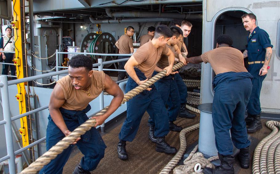 Sailors handle a mooring line on the fantail as the USS Ronald Reagan pulls into Naval Base Guam for a scheduled port visit June 19, 2024.