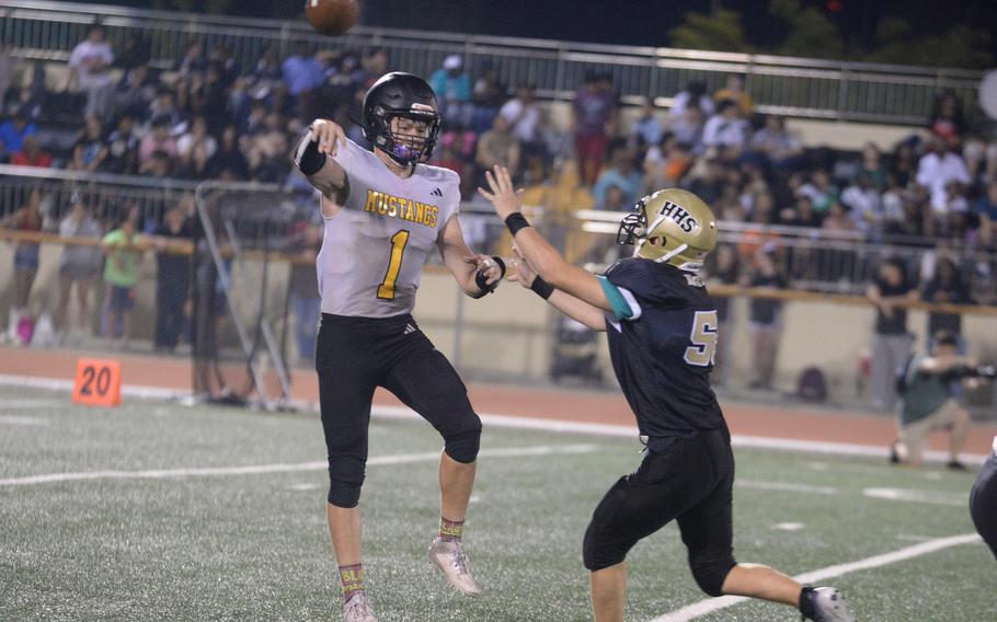 ASIJ quarterback throws a pass.