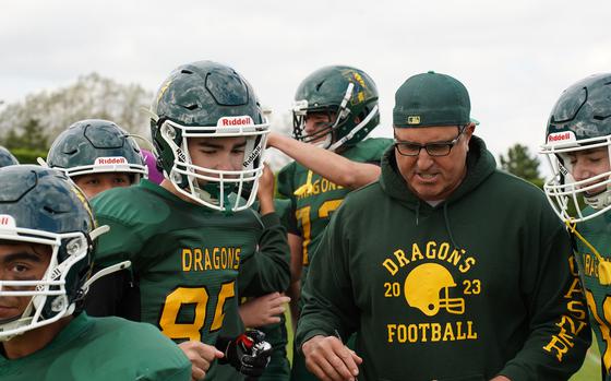 During a timeout, Alconbury coach Steve Casner huddles his team to reassess the playing field. After this huddle, the team proceeded to dominate the game.