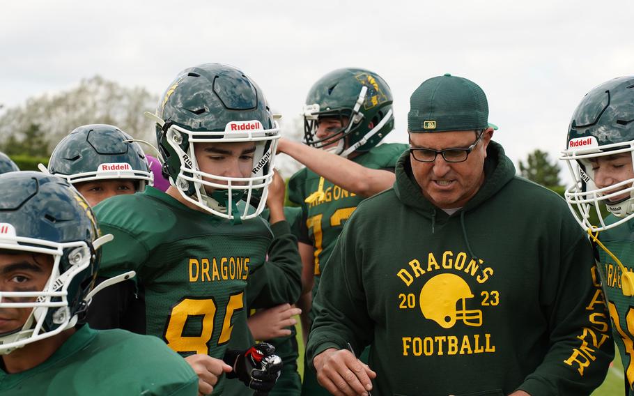 The Alconbury Dragons huddle with their coach.