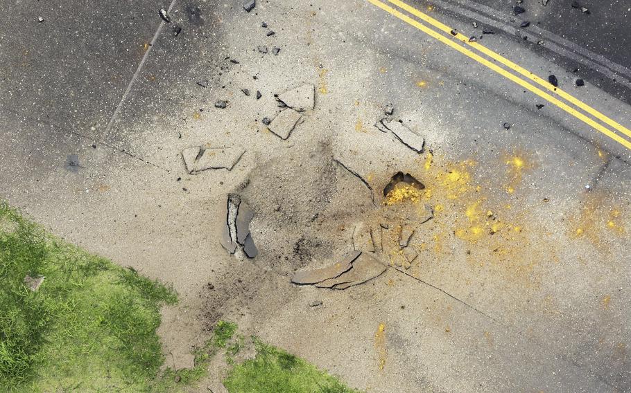 An aerial view of the damage to a taxiway at Miyazaki airport caused by the explosion of a World War II bomb.