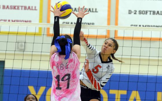 King's Mila Nishimura-Reed spikes against CAJ's Sakurako Abe during Saturday's Division II volleyball semifinal. The Knights outlasted the Cobras in five sets.