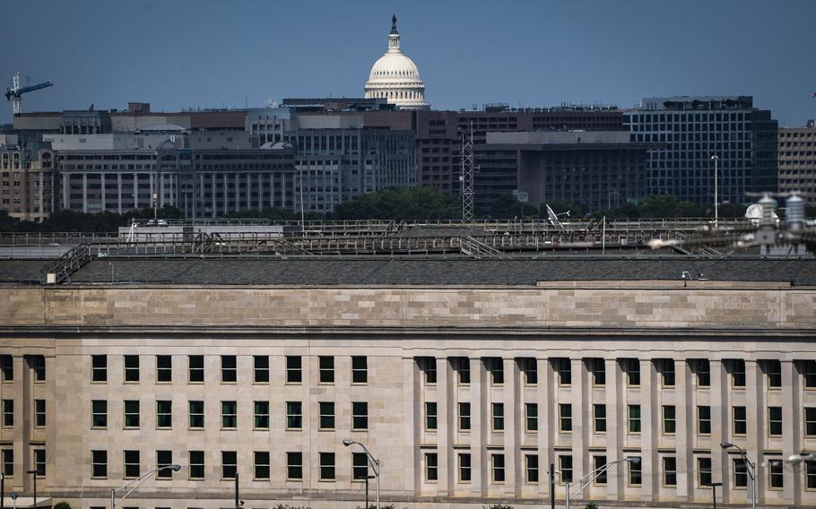 A view of one side of the Pentagon with the U.S. Capitol dome visible in the background.