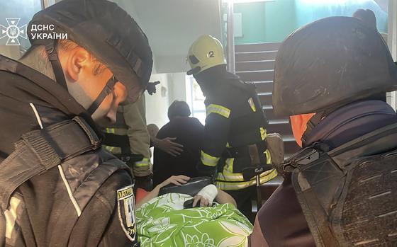 In this photo provided by the Ukrainian Emergency Service, emergency services workers evacuate patients after Russian attacks on a medical center in the northeastern Ukrainian city of Sumy Saturday, Sept. 28, 2024. (Ukrainian Emergency Service via AP)