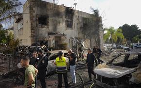 Israeli security forces examine the site hit by a rocket fired from Lebanon, in Kiryat Bialik, northern Israel, on Sunday, Sept. 22, 2024.