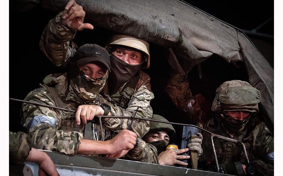 Members of Wagner group look from a military vehicle in Rostov-on-Don late on June 24, 2023. 