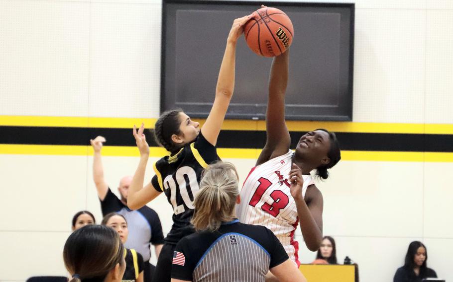 Danielle Hamilton and Janavi Livezey reach for the ball.