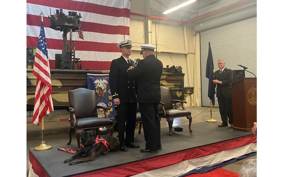 U.S. Navy veteran Lawrence “Otter” Obst and his service dog, Kimber, at his retirement ceremony in March. Obst says that the dog has changed his life.