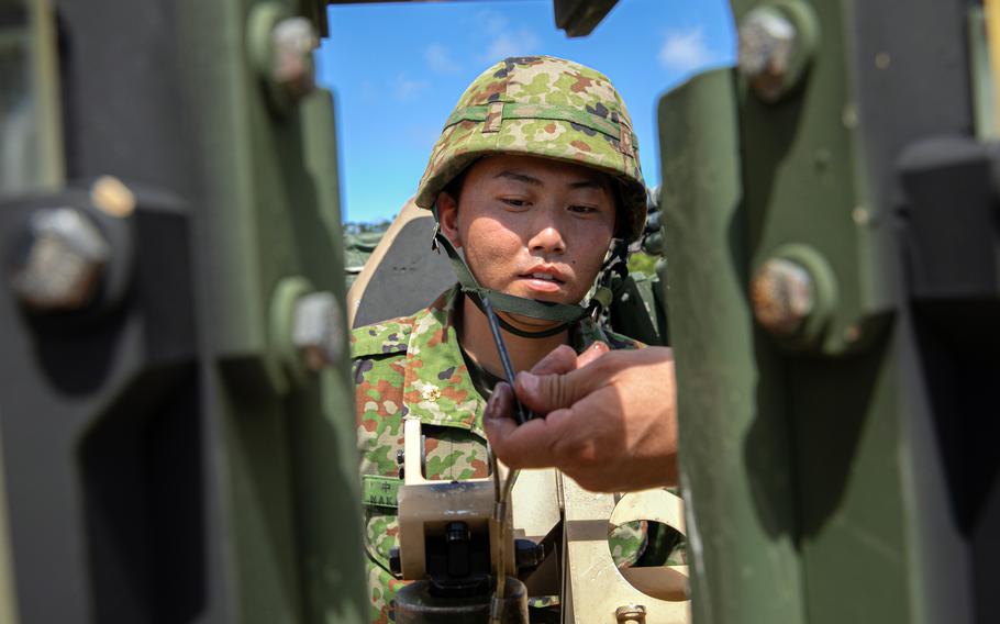 A Japanese soldier learns how to operate an M240B machine gun attached to a tactical vehicle during Resolute Dragon training in Dodo, Okinawa, Aug. 1, 2024.