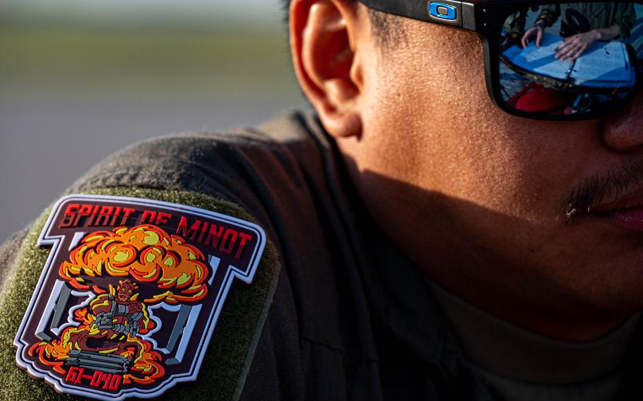 U.S. Air Force Christian Limos, 23rd Bomb Squadron flying crew chief, reads over flight plans with a B-52H Stratofortress pilot in support of exercise Agile Warbird at Minot Air Force Base, N.D., July 15, 2024. Flying crew chiefs are specially trained maintenance personnel who attend a six-week maintenance special operations course in addition to the hundreds of hours of training it takes to become a 7-level maintainer.