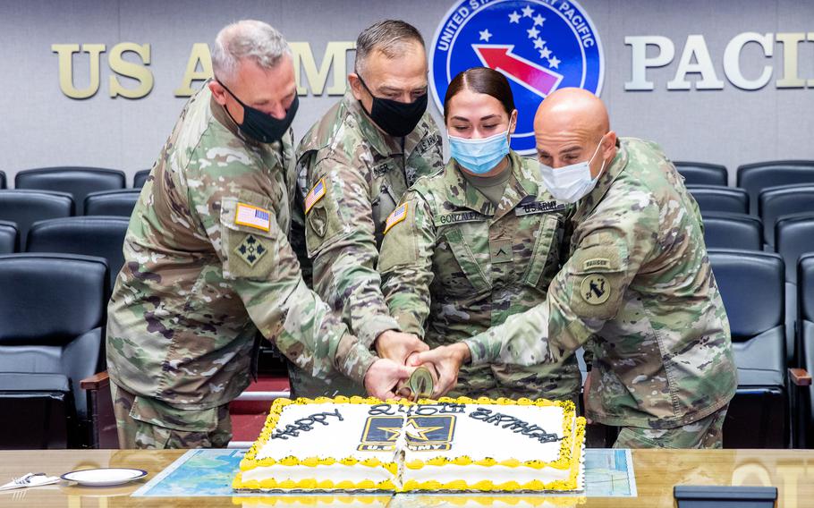 Lt. Col. Austin Hamner, second from left, helps U.S. Army Pacific's then-commander, Gen. Paul LaCamera, far left, and other soldiers celebrate the Army's 245th birthday at Fort Shafter, Hawaii, June 9, 2020.