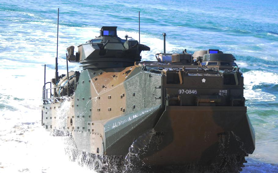 A Japanese amphibious assault vehicle rolls onto Kin Blue Beach.