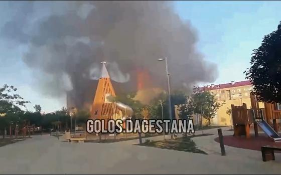 This photo taken from video released by Golos Dagestana shows smoke rises following an attack in Makhachkala, republic of Dagestan, Russia, Sunday, June 23, 2024. Russian state news agency RIA Novosti says that armed militants attacked two Orthodox churches, a synagogue and a traffic police post in Russia's southern republic of Dagestan, killing a priest and six police officers. (Golos Dagestana via AP)