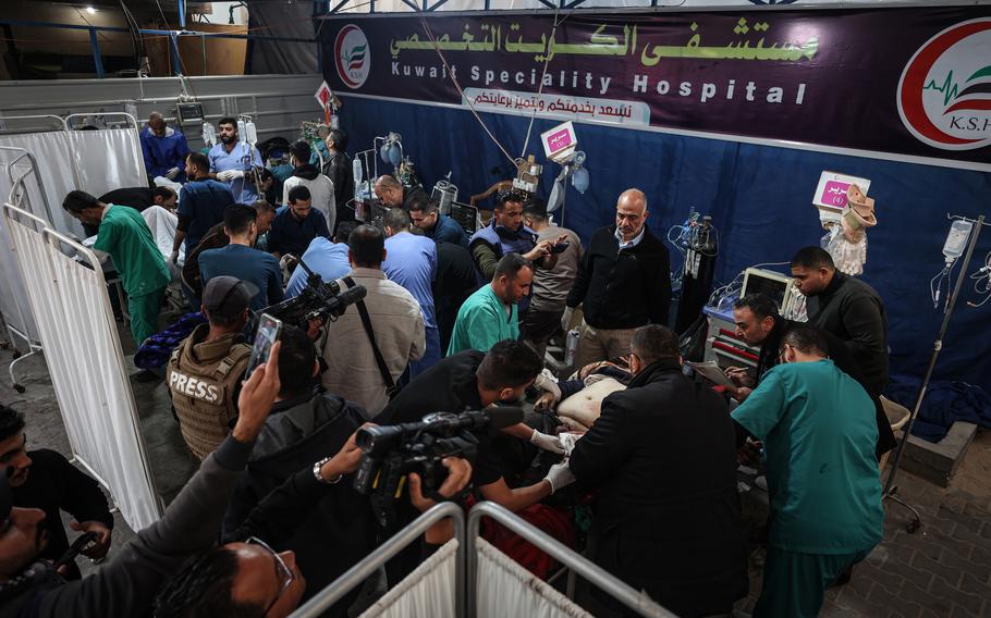 Medical personnel at Kuwaiti Hospital treat a rush of wounded people after a strike hit a house last week in central Rafah. 