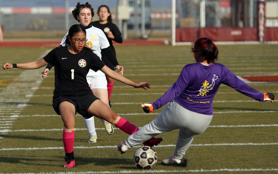 Matthew C. Perry's Elieza Cuaco and Yokota keeper Marisela Post tangle for the ball during Friday's DODEA-Japan girls soccer match. The Panthers won 3-0.