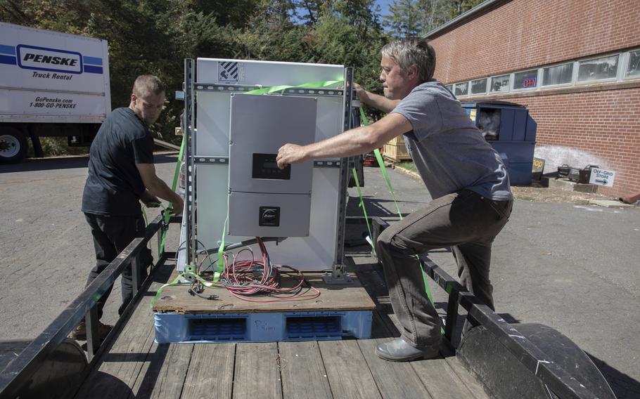 Volunteers with the Footprint Project load Tesla Powerwall batteries to help people who lost power during Hurricane Helene.