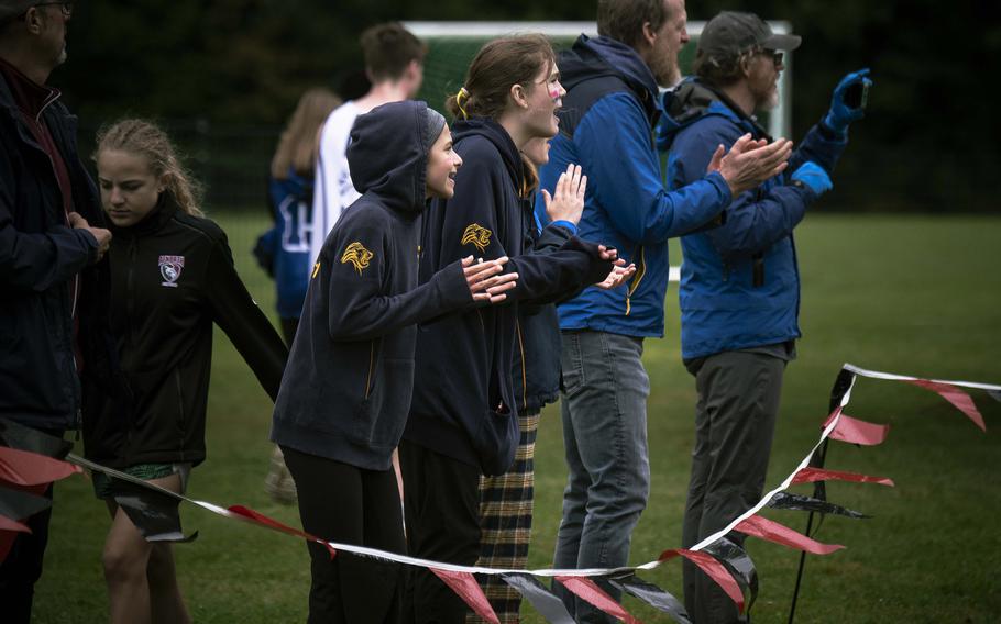 Zurich International School cross country runners cheer on their male teammates crossing the finish line Saturday, Sept. 14, 2024. 