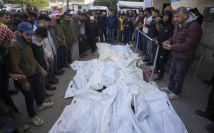 Palestinians attend funeral prayers over the bodies of those killed in overnight Israeli airstrikes on the Maghazi refugee camp, at Al-Aqsa Hospital, in Deir al-Balah, central Gaza Strip, Saturday, Dec. 28, 2024. (AP Photo/Abdel Kareem Hana)