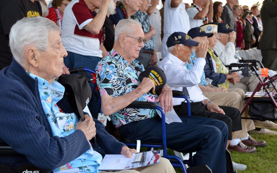 Six veterans who survived the 1941 attack on Pearl Harbor salute the flag as the national anthem is played during a ceremony at Pearl Harbor National Memorial, Hawaii, Dec. 7, 2023, on the attack’s 82nd anniversary.
