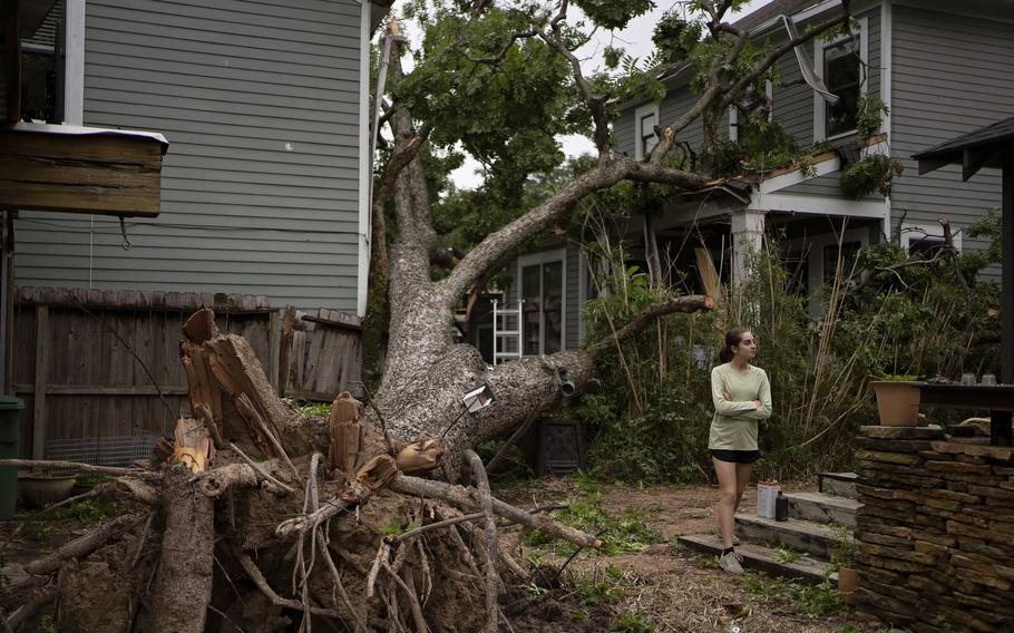 Anita Wolfsteiner walks through a neighbor’s yard in Houston after Hurricane Beryl in July. Not only can branches cause roof damage, but as trees grow, their root systems can also damage pipes and create plumbing issues, says Tony Cammarota, a real estate agent with RE/MAX Distinctive in Washington. 